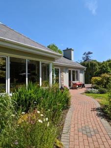 a house with a brick walkway in front of it at Applecroft House in Killarney