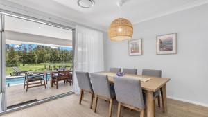 a dining room with a table and chairs at Kokoon in Pokolbin
