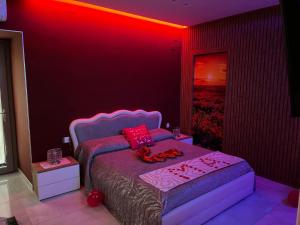 a bedroom with a bed with a red lighting at Terraforte Luxury Suite in Fisciano