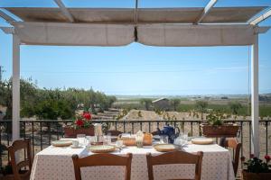 a table with food on top of a balcony with a view at Oasi Orange Villa with Jacuzzi in Paterno