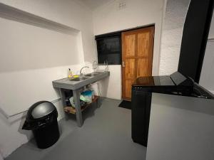 a bathroom with a sink and a trash can at Blue Moon Guest Rooms in Bellville