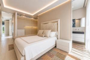 a bedroom with a large white bed in a room at Luxury Home & Pool by Symphonya Luxury Holiday Rentals in Lequile +37 photos