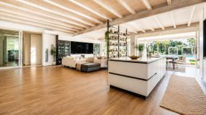 a living room with a kitchen and a living room with a table at Luxury Home & Pool by Symphonya Luxury Holiday Rentals in Lequile