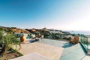 a patio with a view of the ocean at Michelle Villa in vlicha