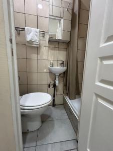 a bathroom with a toilet and a sink at myappart - La Garenne in La Garenne-Colombes +7 photos