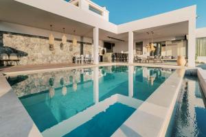 a swimming pool in a villa with a house at Michelle Villa in vlicha