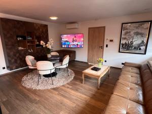 a living room with a couch and a table at Villa de Luxe - Parking Gratuit in Hensies