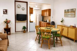 a kitchen and dining room with a table and chairs at Eva's House in Amarynthos