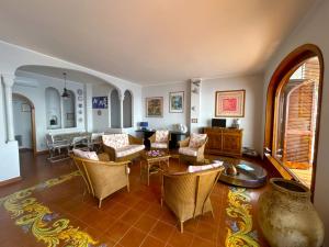 a living room with chairs and a table at Villa Azzurra in Conca dei Marini
