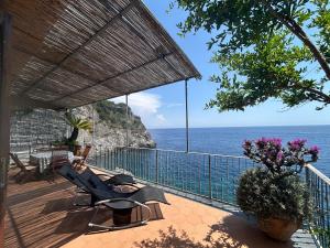 a balcony with chairs and a view of the ocean at Villa Azzurra in Conca dei Marini