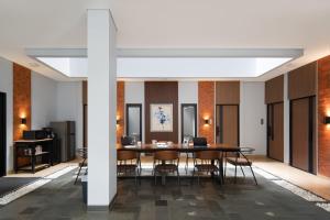 a large dining room with a table and chairs at Cove Good Friends in Busuk 1