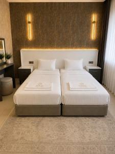 a bedroom with two beds and two night stands at Royal Fsm Suites in Istanbul