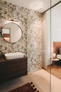 a bathroom with a sink and a mirror at New Opening Grafferhof in Bolzano +38 photos