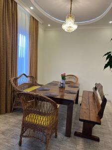 a dining room with a table and chairs and a chandelier at Арендное жилье Лиманка in Odesa