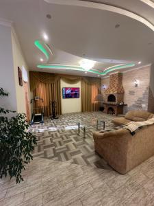 a large lobby with a couch and a fireplace at Арендное жилье Лиманка in Odesa