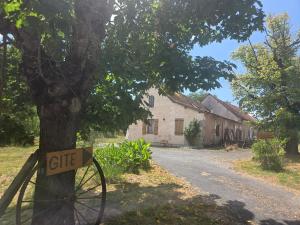 a sign on a tree next to a street at La Chataîgnière in Saint-Géry +8 photos
