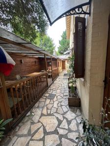 a stone walkway leading to a building with a balcony at myappart - La Garenne in La Garenne-Colombes