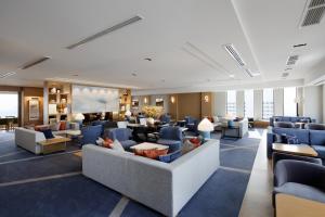 a hotel lobby with couches and tables and chairs at Keio Plaza Hotel Tokyo in Tokyo