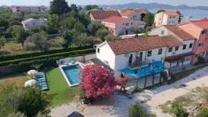 an aerial view of a house with a swimming pool at Mermaid Cove in Sukošan