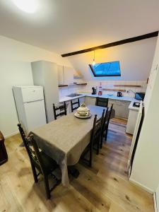 a kitchen and dining room with a table and chairs at Albergue Bosquet in Brussels