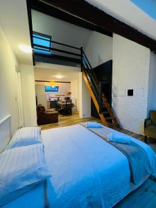 a bedroom with a large bed and a staircase at Albergue Bosquet in Brussels