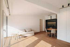 a living room with a couch and a table at New Opening Grafferhof in Bolzano