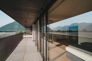 a building with a balcony with a view of the water at New Opening Grafferhof in Bolzano