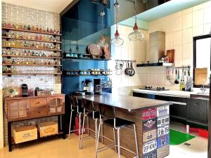 a kitchen with a counter with stools in it at 漫調子 Roaming Life in Wujie
