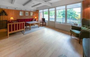 a living room with a couch and a table at Beautiful Home In Ørsted With Wifi in Ørsted