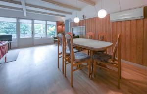 a dining room with a table and chairs at Beautiful Home In Ørsted With Wifi in Ørsted