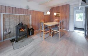 a dining room with a table and a wood stove at Beautiful Home In Ørsted With Wifi in Ørsted