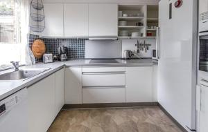 a white kitchen with white cabinets and a sink at Beautiful Home In Ørsted With Wifi in Ørsted