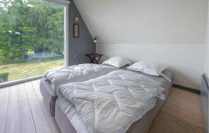 a bedroom with two beds and a large window at Beautiful Home In Ørsted With Wifi in Ørsted +7 photos