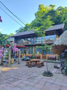 a building with a picnic table in front of it at Homestay field - bungalow, Ha giang loop tour, motorbikes rental in Ha Giang