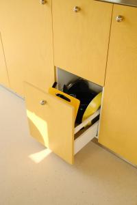 a yellow cupboard with a kitchen utensilventory at Oseraie Cabins - Wild lodges entre Liège et Maastricht in Visé