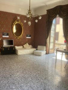a living room with a couch and a mirror at Coremi Naples in Naples