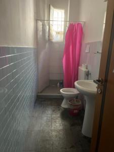 a bathroom with a toilet and a sink at Coremi Naples in Naples