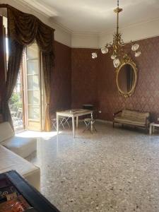 a living room with a table and a mirror at Coremi Naples in Naples