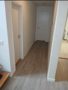 an empty room with a hallway with a white door at Great place to see the solar eclipse! in Patreksfjörður +1 photo