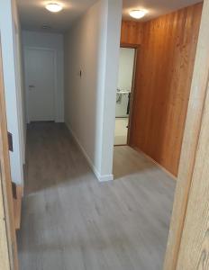 an empty living room with a hallway and a door at Great place to see the solar eclipse! in Patreksfjörður