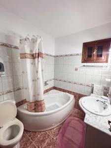 a bathroom with a tub and a toilet and a sink at Ocean Peak Villa in Kalymnos +59 photos
