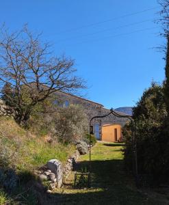 an entrance to a building with a gate in the grass at Campagne Vallauris chambres in Sisteron