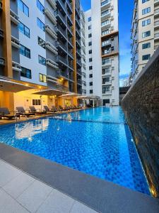 a large swimming pool in the middle of a building at Two Regis Bacolod Cozy 1BR Condo with Balcony in Bacolod