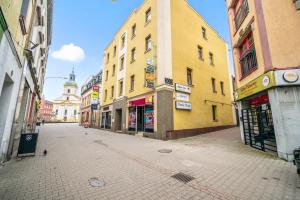 an empty street in a city with buildings at Centrum Grand Apartments in Rybnik