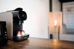 a coffee maker sitting on top of a wooden table at Peperu Lodge - bungalow piscine privée in Punaauia