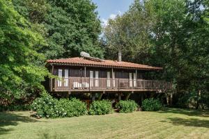 a large house with a deck in the yard at Quinta Lamosa Agroturismo in Arcos de Valdevez