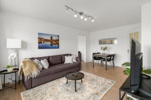 a living room with a couch and a table at AirHosted - Lucerne City Centre in Lucerne