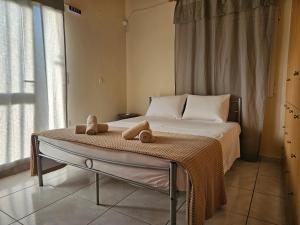 a bedroom with a bed with towels on it at Seven Plus in Filiatra