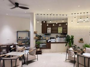 a restaurant with tables and chairs and a counter at Olivea Boutique Hotel Phu Quoc in Phú Quốc