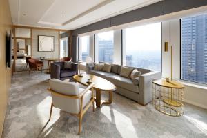 a living room with a couch and a table at Keio Plaza Hotel Tokyo in Tokyo